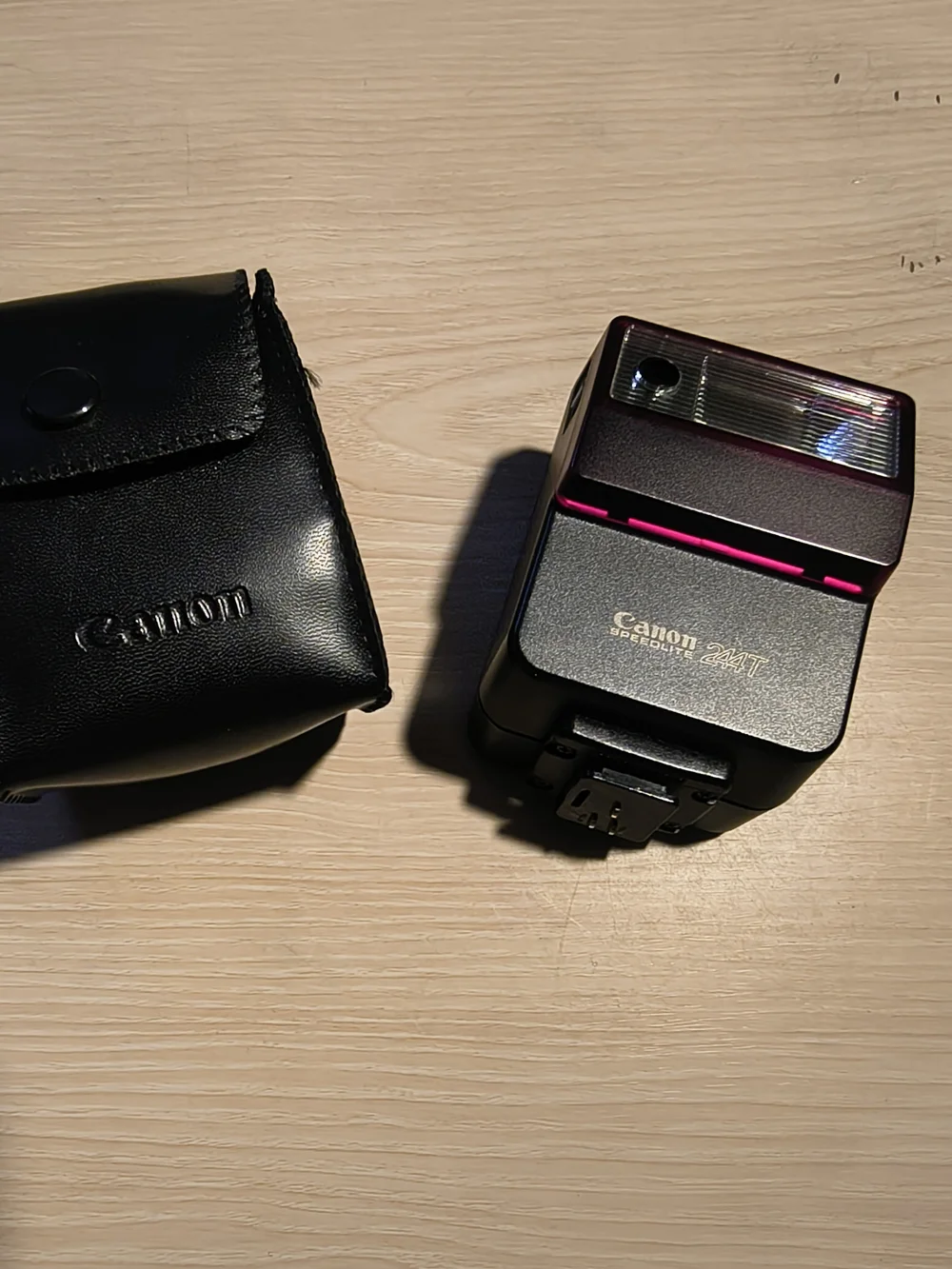 vintage Canon Speedlite 244T electronic flash unit with its leather case,